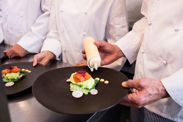 Chef decorating a food plate