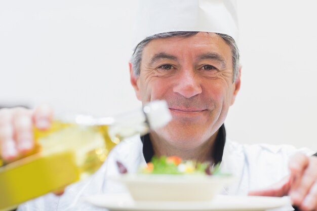 Chef dressing a salad