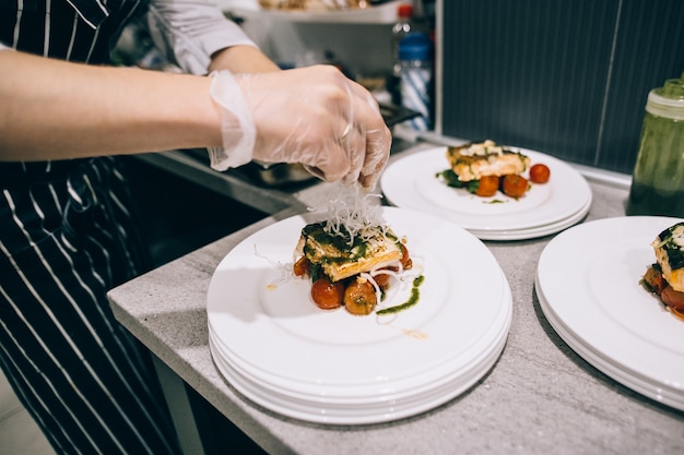 Chef finishing food in his restaurant kitchen