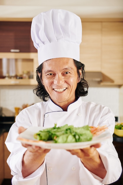 Chef giving plate of salad