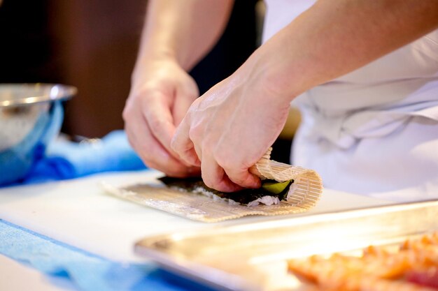 chef hands preparing japanese food chef making sushi Preparing Maki Sushi roll