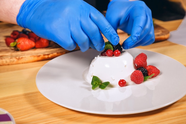 Chef hands with blue gloves cooked