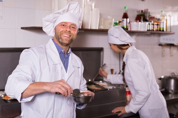 Chef and his helper at bistro kitchen