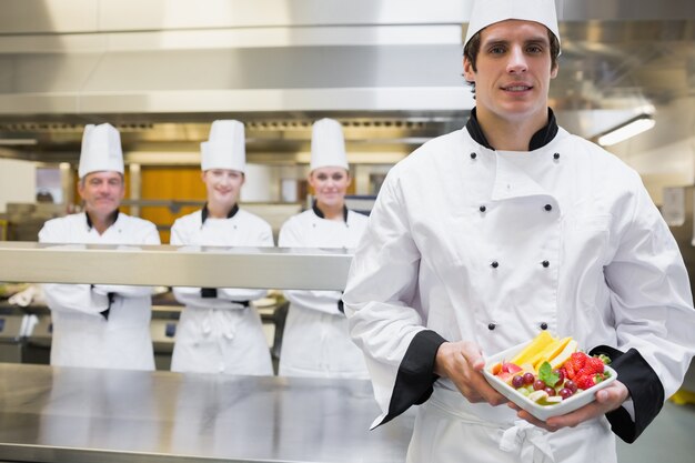 Chef holding fruit salad 