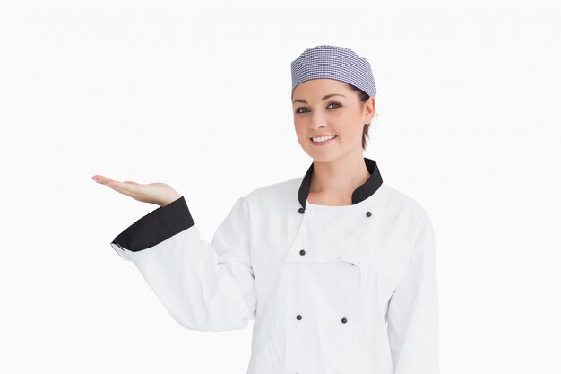 Chef holding out hand in presentation