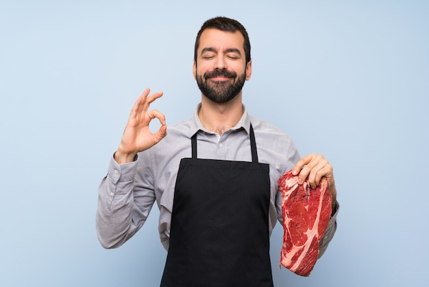 Photo chef holding a raw meat in zen pose