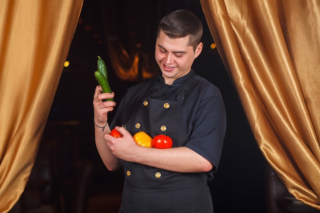 Chef holds vegetables in his hands