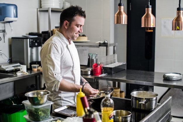 chef is making flambe in a restaurant kitchen