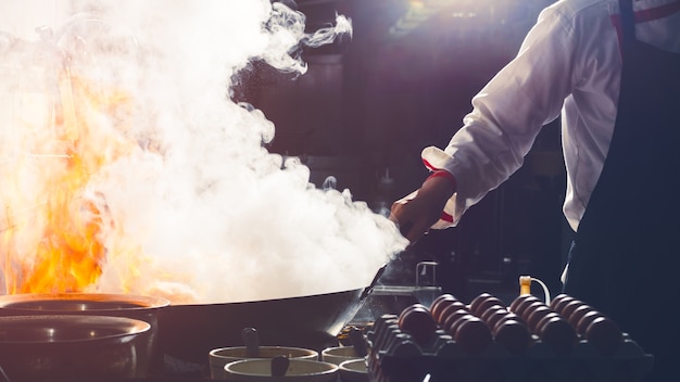 Chef is stirring vegetables