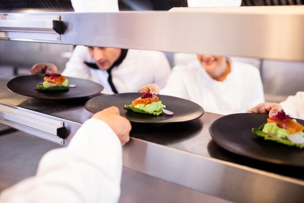 Chef keeping appetizer plate ready on the order station