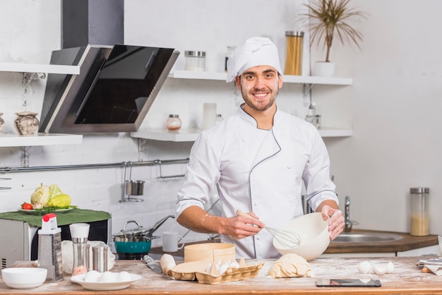 Chef in kitchen making dough