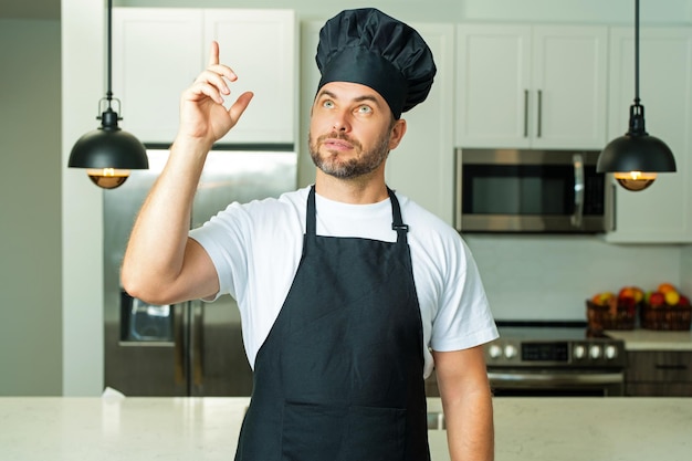 Photo chef on kitchen professional chef man in uniform on kitchen bearded chef cook or baker male chef ove