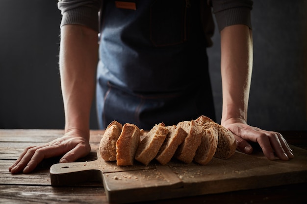 Chef-kok met de hand zelfgemaakt gesneden brood snijden