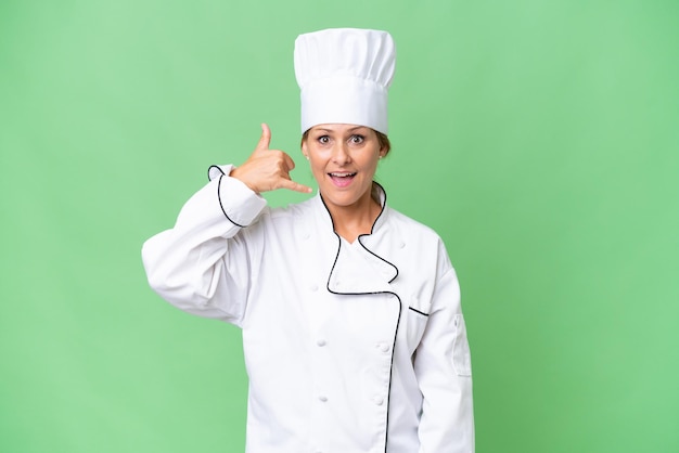 Foto chef-kokvrouw van middelbare leeftijd over geïsoleerde achtergrond die telefoongebaar maakt bel me terug teken