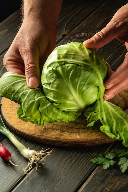 The chef makes a fresh cabbage salad Preparation on a cutting board vegetable diet idea