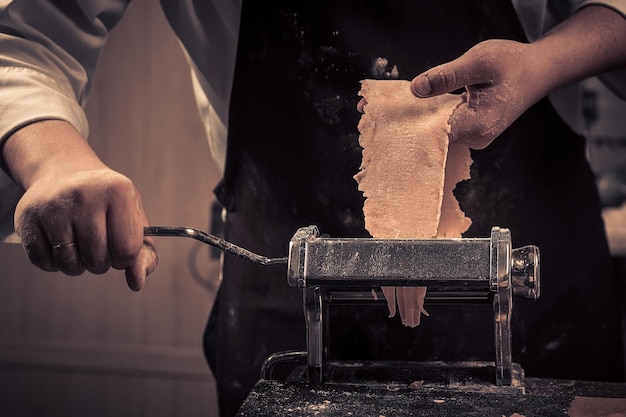 The chef makes fresh spaghetti from scratch