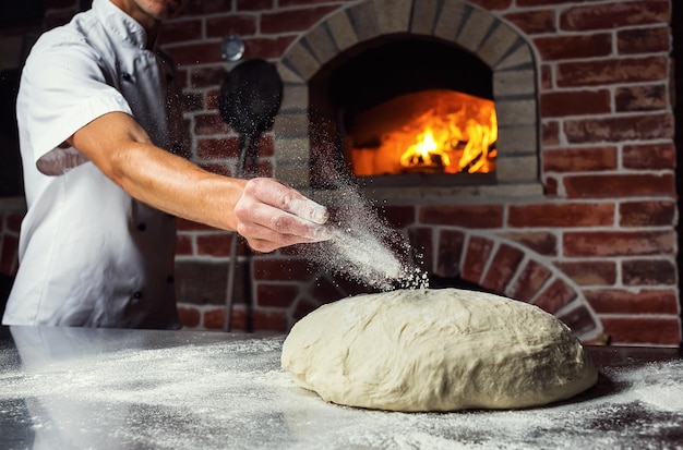 Chef making dough for pizza Man hands preparing bread Concept of baking and patisserie