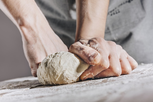 Chef making and kneading fresh dough