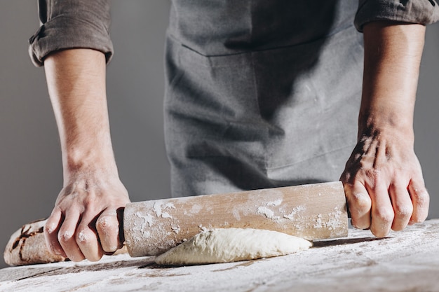 Chef making and kneading fresh dough