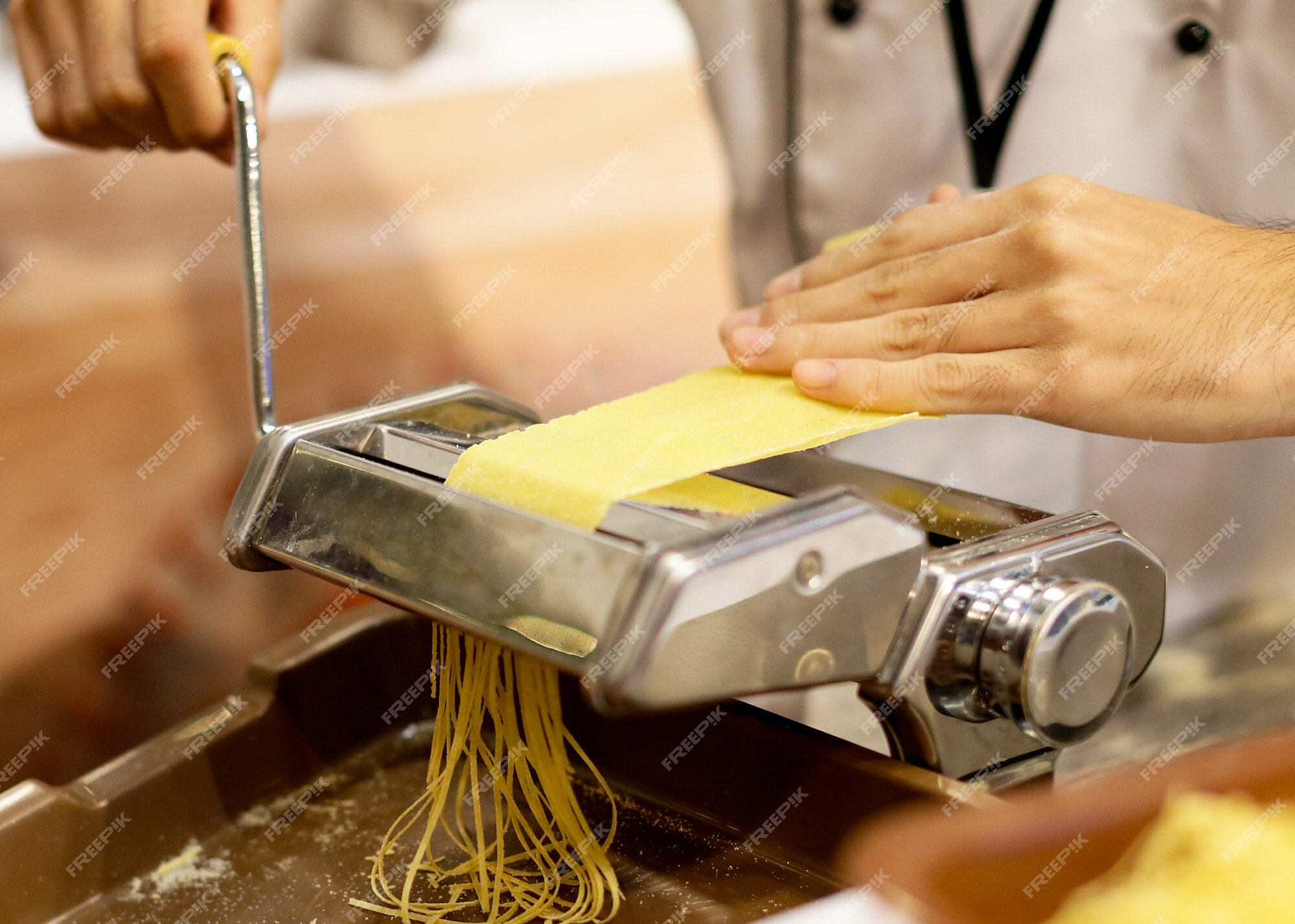 https://img.freepik.com/premium-photo/chef-making-pasta-with-machine-home-made-fresh-pasta_67394-335.jpg?w=2000