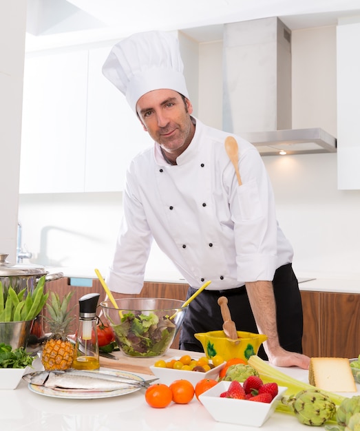 Chef male portrait on white countertop at kitchen