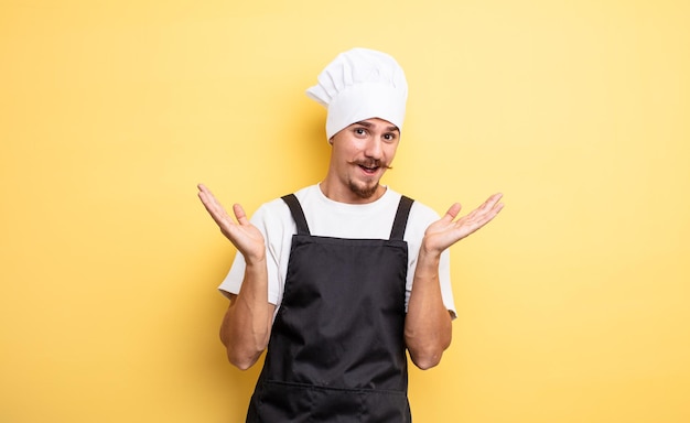 Chef man feeling happy and astonished at something unbelievable