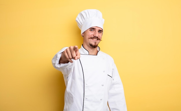 Chef man pointing at camera choosing you