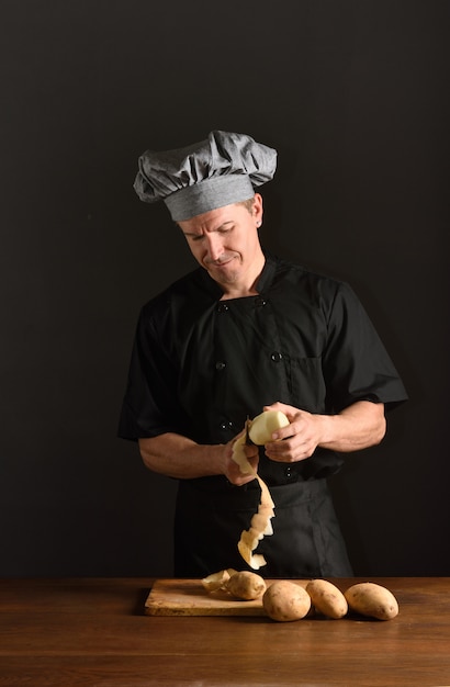 Chef peeling potatoes