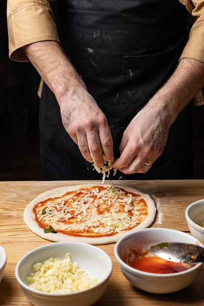 the chef prepares delicious pizza in the restaurant. Close-up