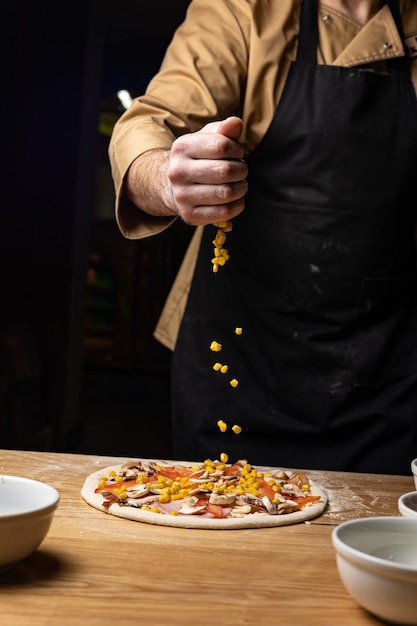 the chef prepares delicious pizza in the restaurant. Close-up