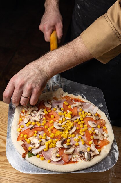 the chef prepares delicious pizza in the restaurant. Close-up