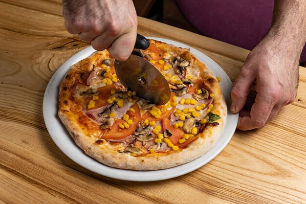 the chef prepares delicious pizza in the restaurant. Close-up