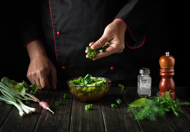 The chef prepares food from fresh vegetables in the kitchen