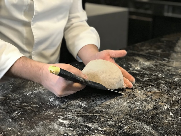 Chef preparing dough on a table
