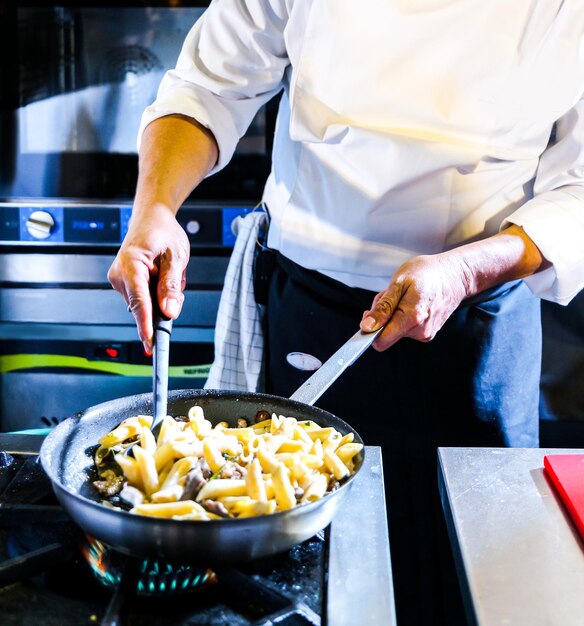 Chef preparing food in the kitchen chef cooking closeup