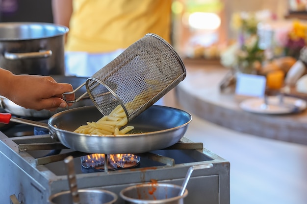 Chef preparing macaroni for a client