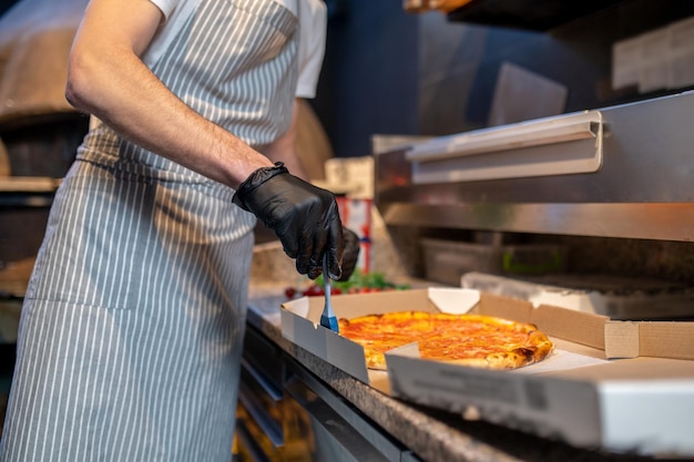 Chef preparing pizza in the bakery shop