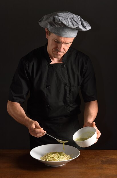 Chef preparing a plate of spaghetti