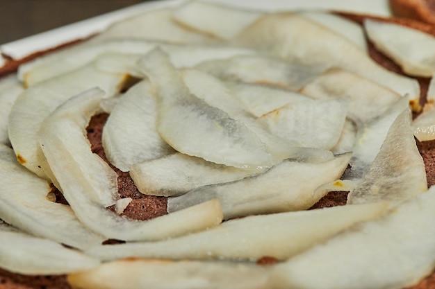 Chef puts the pears inside the pie to make pear and walnut pie