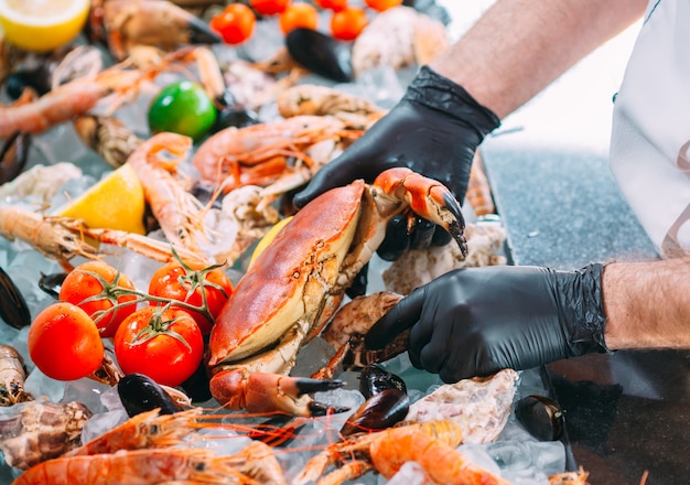 The Chef puts the seafood on a tray in the restaurant.