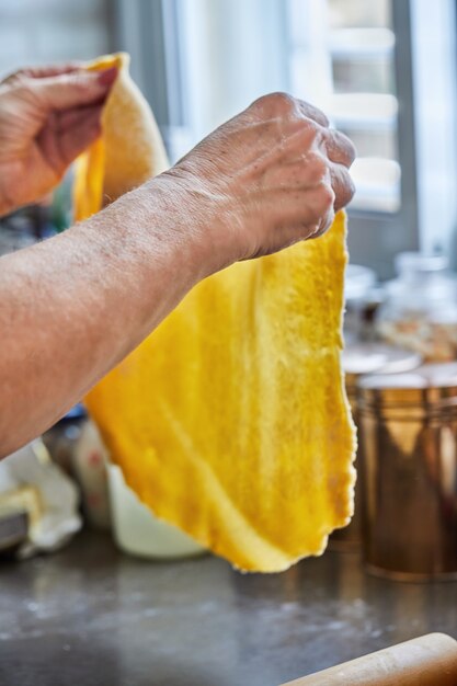 Chef rolls out the dough for making chard pie. step by step recipe