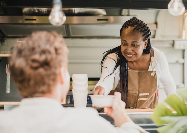 chef serving food at market stall