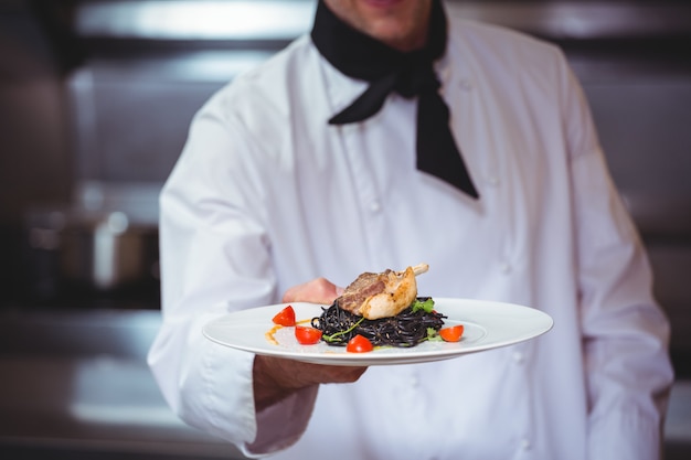 Chef showing plate of spaghetti