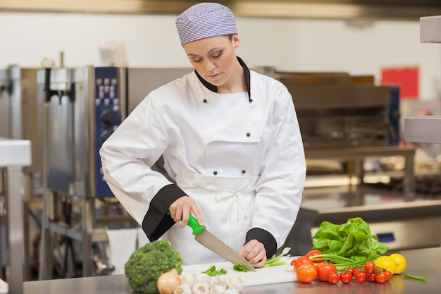 Chef slicing up spring onions