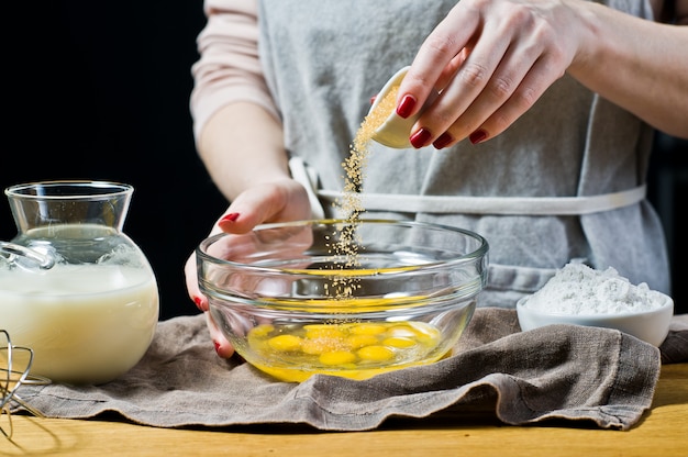 The chef smashes the cane sugar into a bowl. 