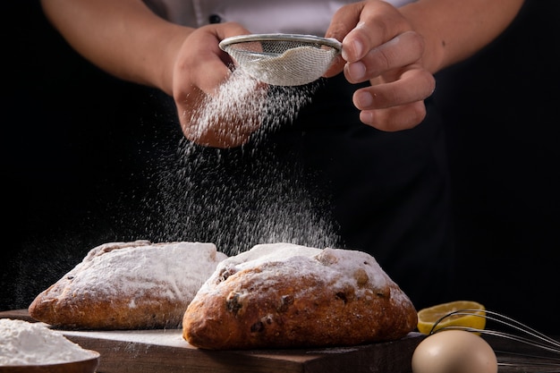 The chef sprinkles the bread