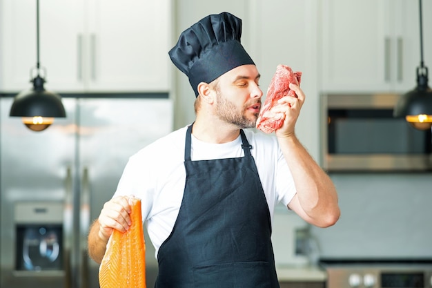 Photo chef in uniform cooking raw meat beef and fish salmon fillet in the kitchen restaurant menu concept