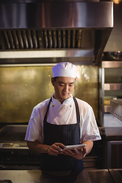 Chef using digital tablet in the kitchen