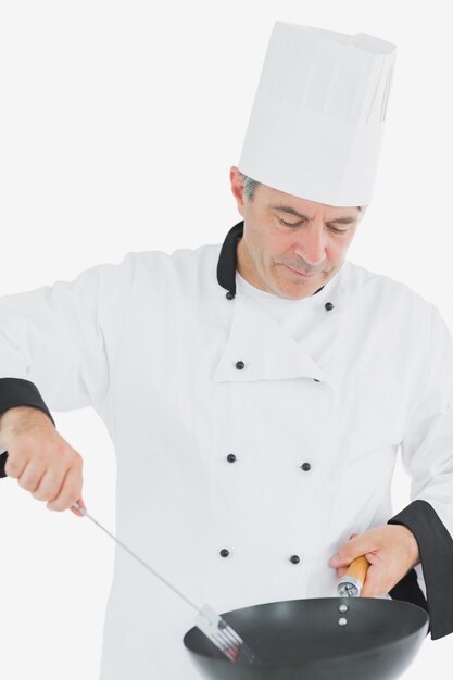 Chef using spatula and frying pan