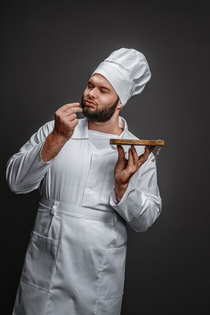 Chef with board kissing fingers